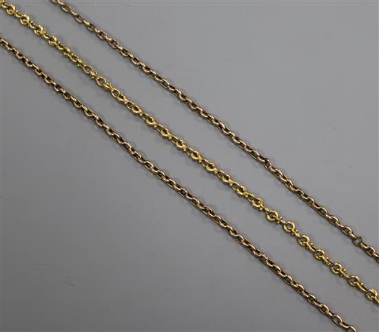 Three yellow metal chain fragments.